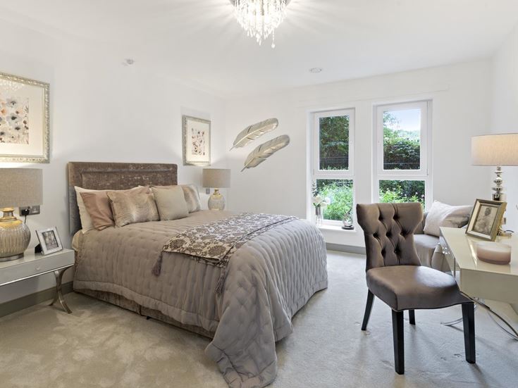 a bedroom with a bed and a chair