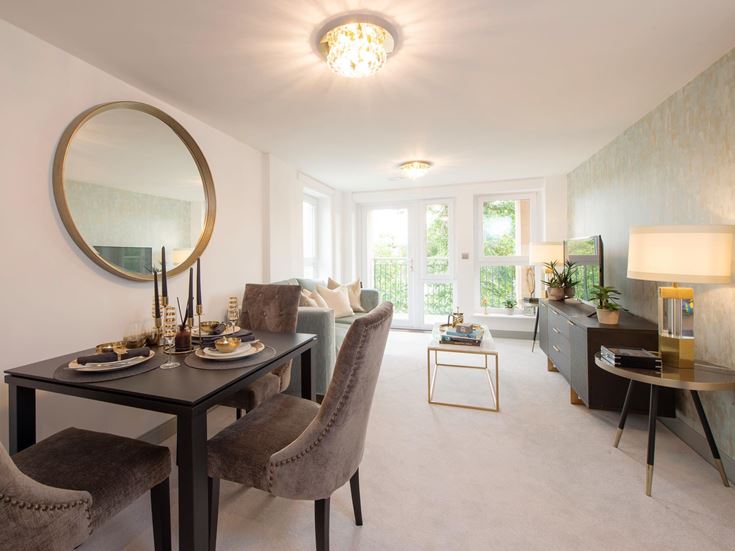 a large living room with a round mirror