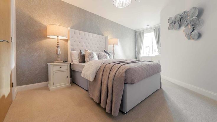 a bedroom with a bed and a lamp