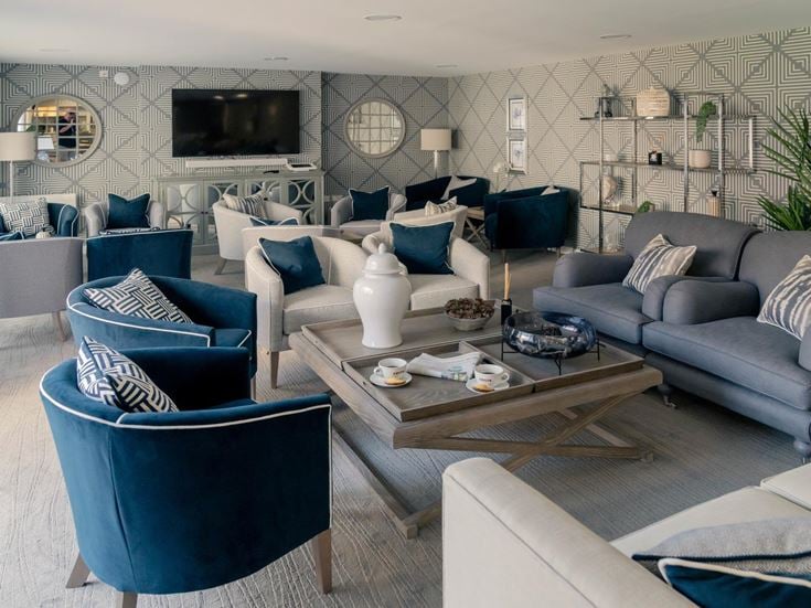 a living room with a couch and chairs