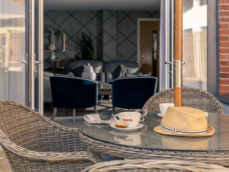 a table with a hat and a cup of coffee on it
