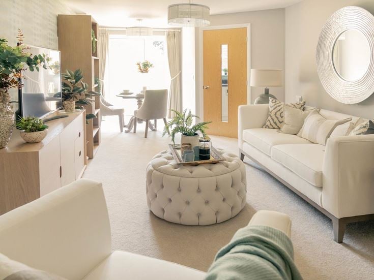 a living room with white furniture