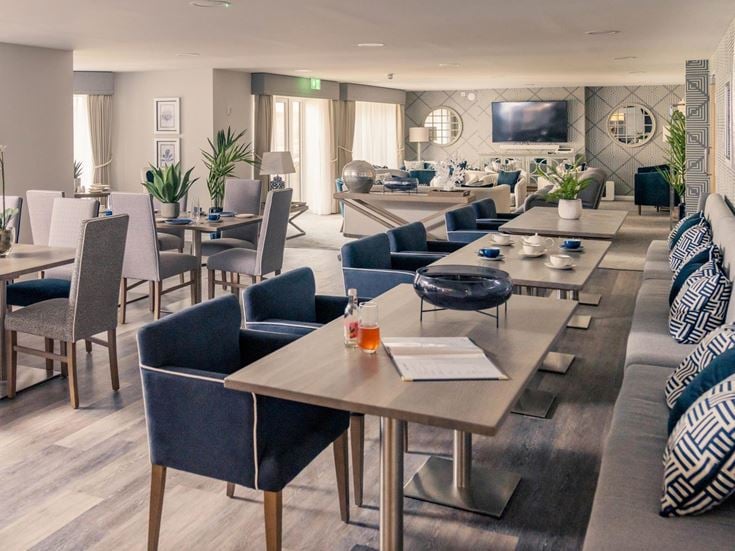a room with a table chairs and a tv