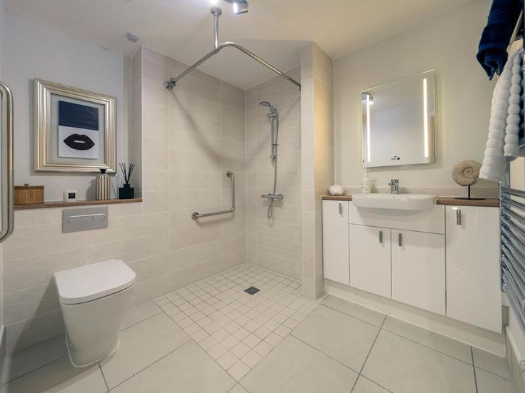 a bathroom with a shower unit and toilet