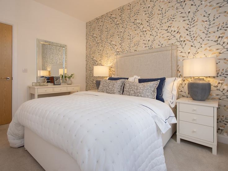 a bedroom with a bed and lamps