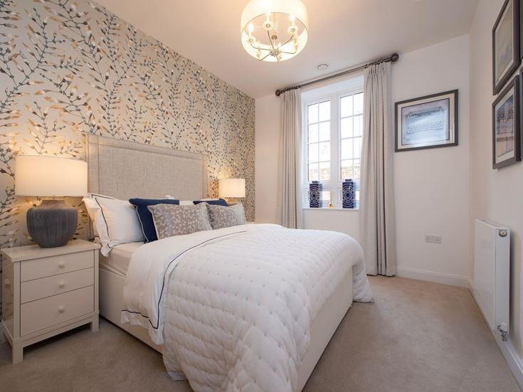 a bedroom with a bed and lamps
