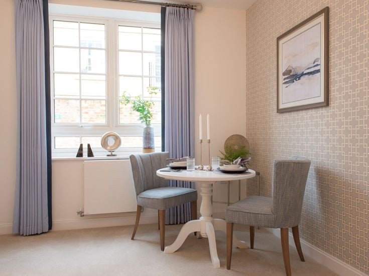 a dining room with a table and chairs
