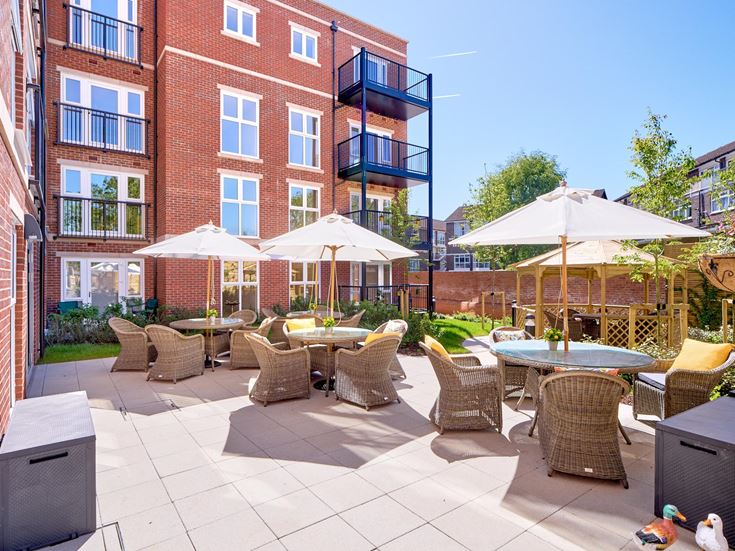 a patio with tables and chairs