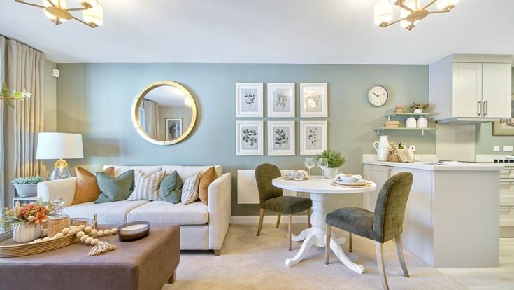 a living room with a table and chairs