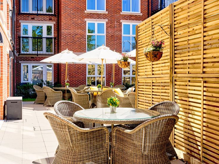 a patio with tables and chairs