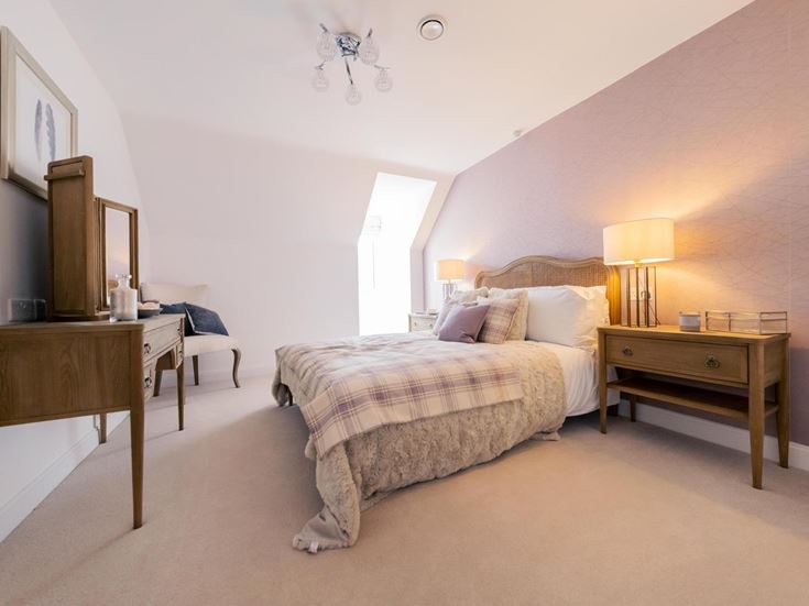 a bedroom with a bed and a desk