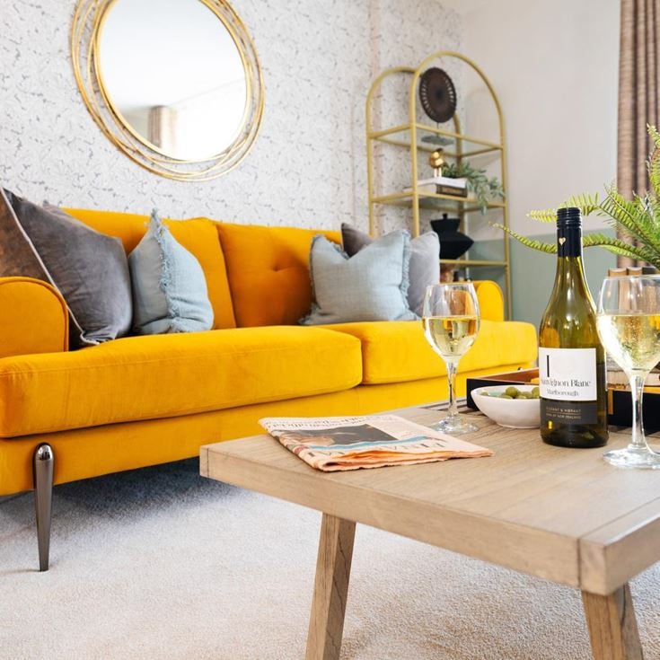 a yellow couch with wine bottles
