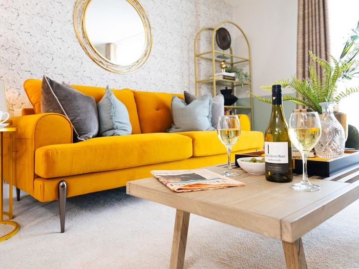 a yellow couch with wine bottles