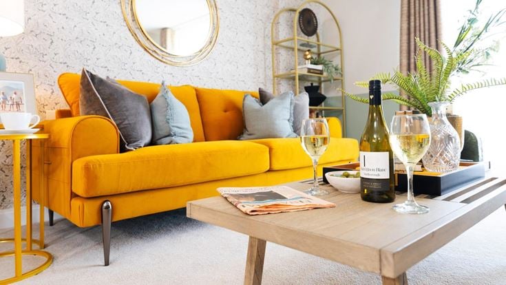 a yellow couch with wine bottles