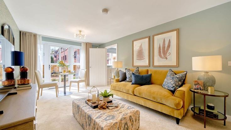 a living room with a yellow couch and a coffee table