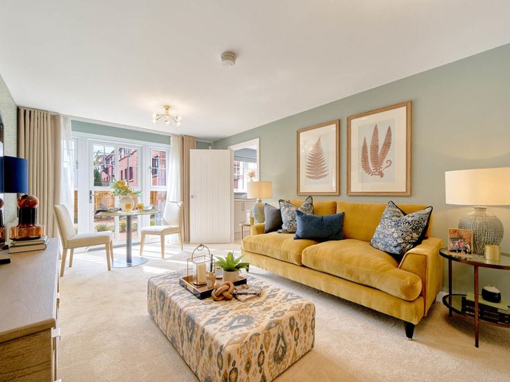 a living room with a yellow couch and a coffee table