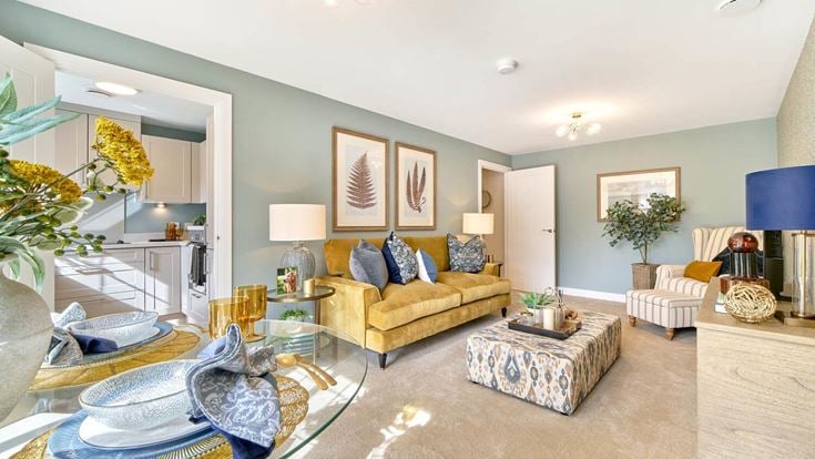 a living room with a large glass table and a large round rug