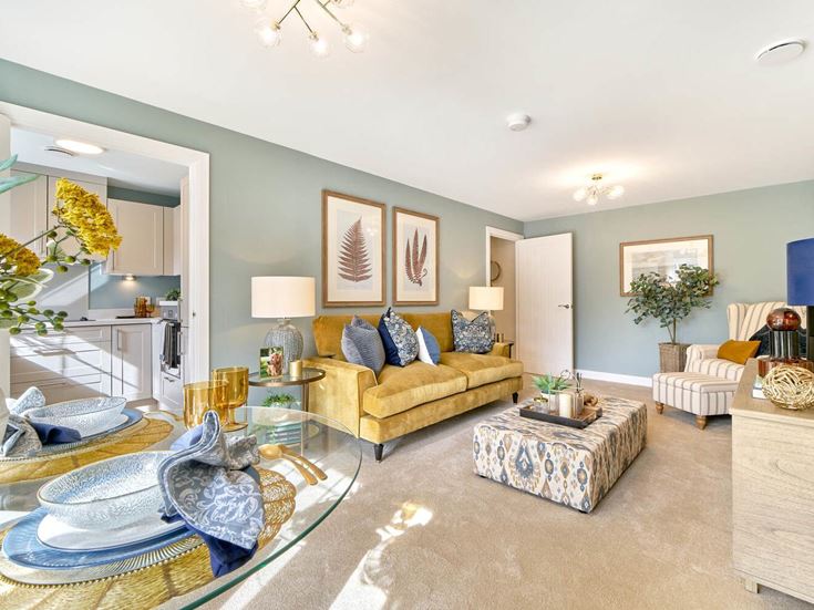 a living room with a large glass table and a large round rug
