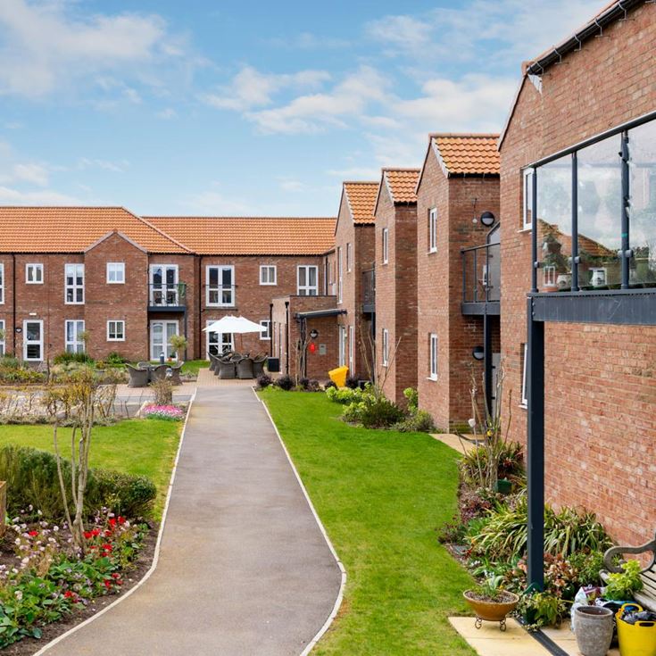 a brick building with a garden