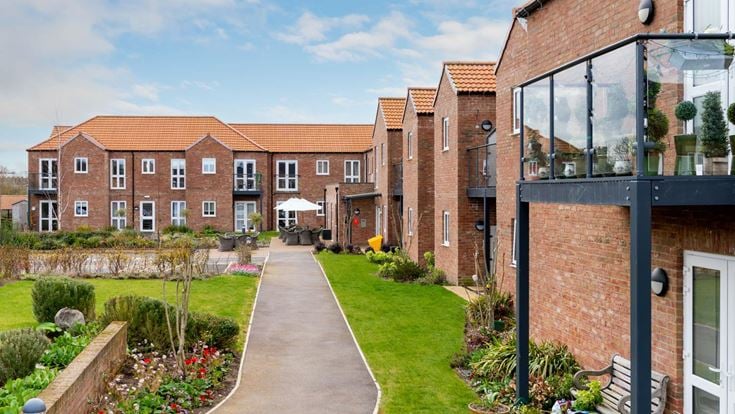 a brick building with a garden
