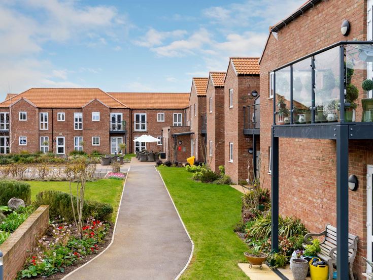 a brick building with a garden