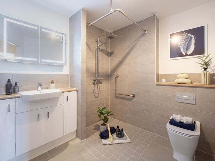 a bathroom with a shower unit and toilet