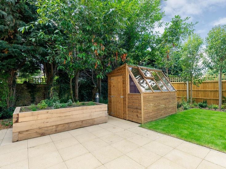 a wood shed in a backyard