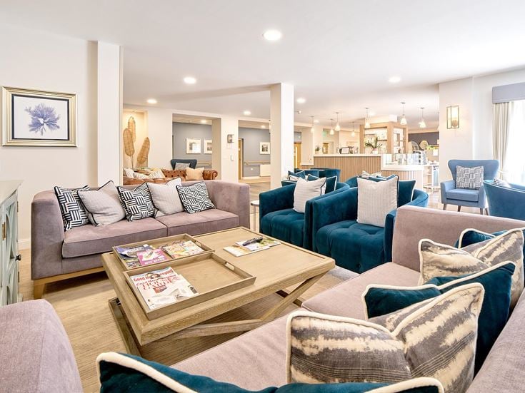 a living room with a couch and chairs