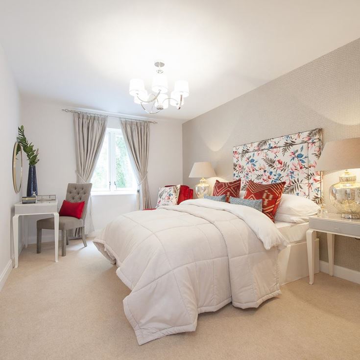a bedroom with a bed and lamps