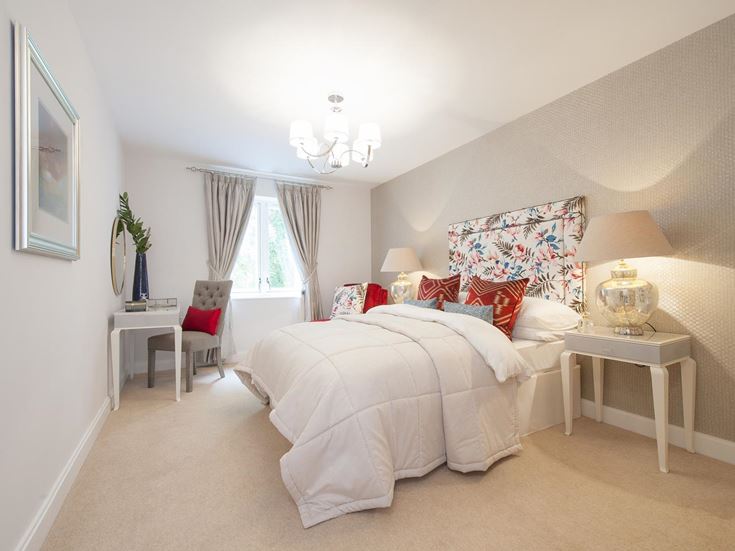 a bedroom with a bed and lamps