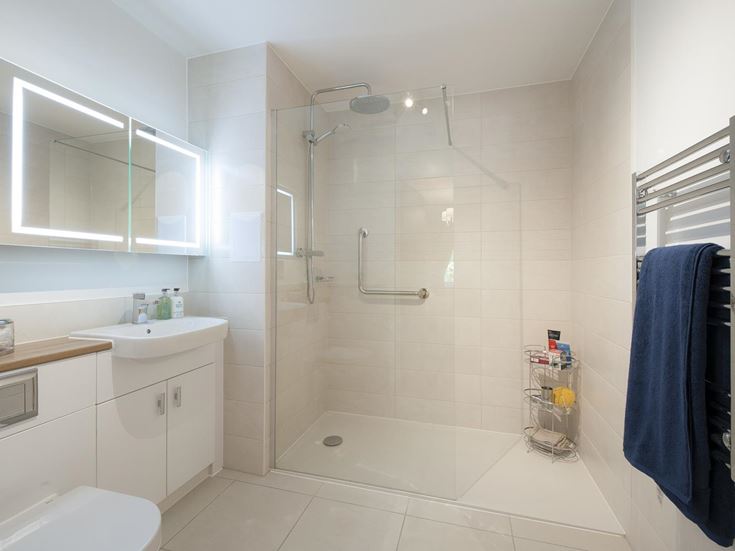 a bathroom with a shower unit and sink