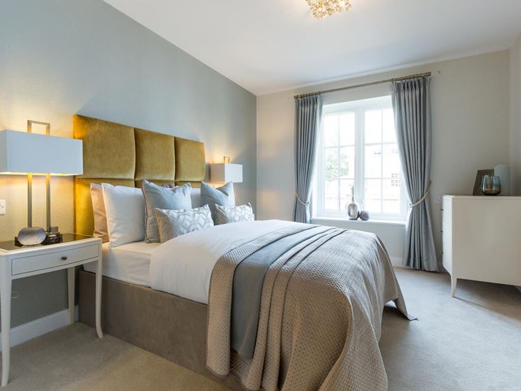 a bedroom with a bed and lamps