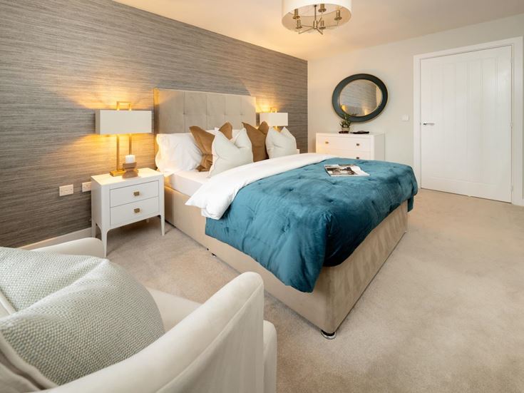 a bedroom with a bed and a chair