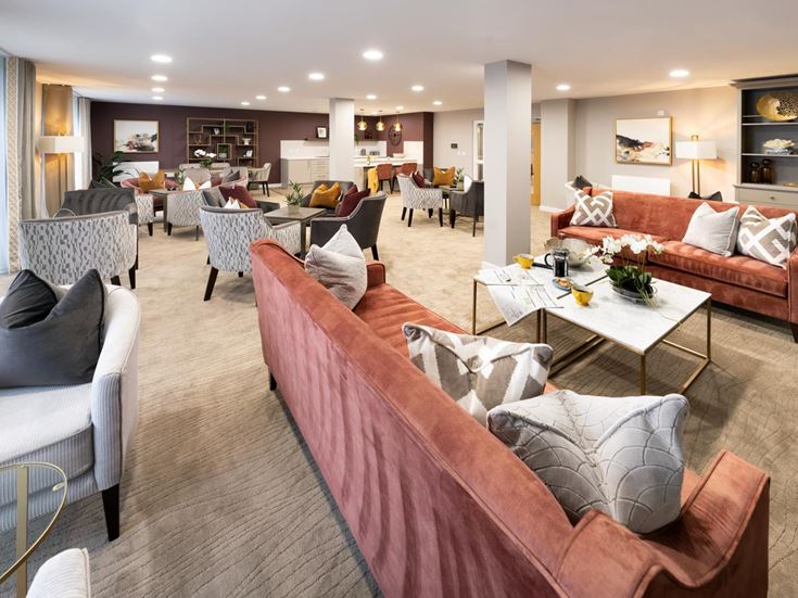 a large living room with a large pink couch and a table