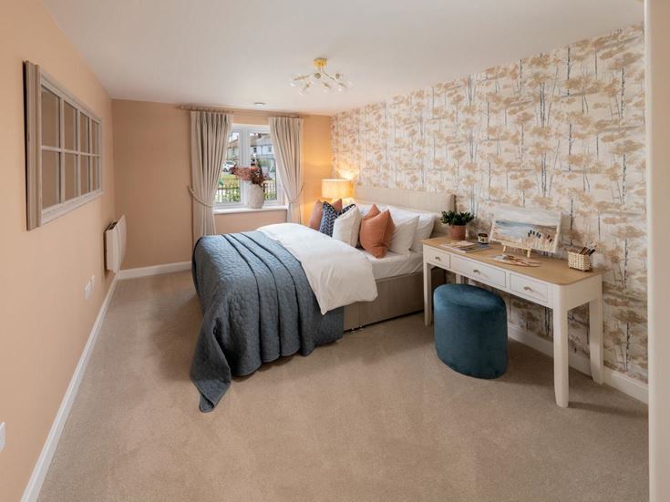 a bedroom with a bed and desk