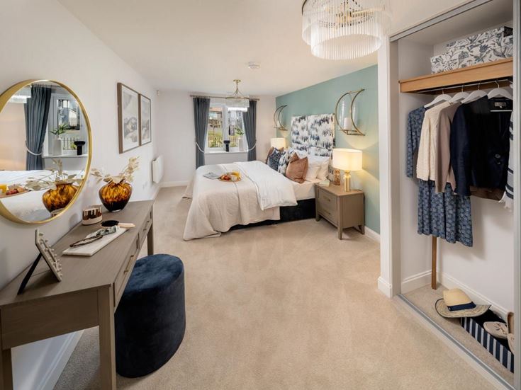 a bedroom with a bed and a desk
