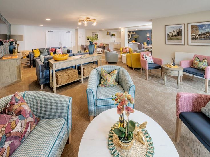 a living room with a large table and chairs