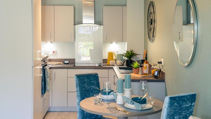 a kitchen with a table and chairs