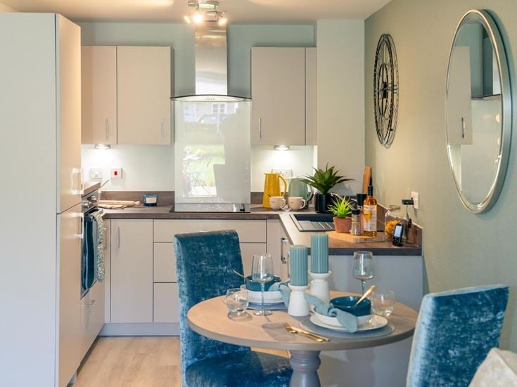 a kitchen with a table and chairs