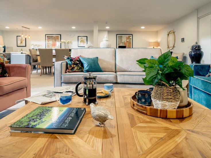 a living room with a table and chairs