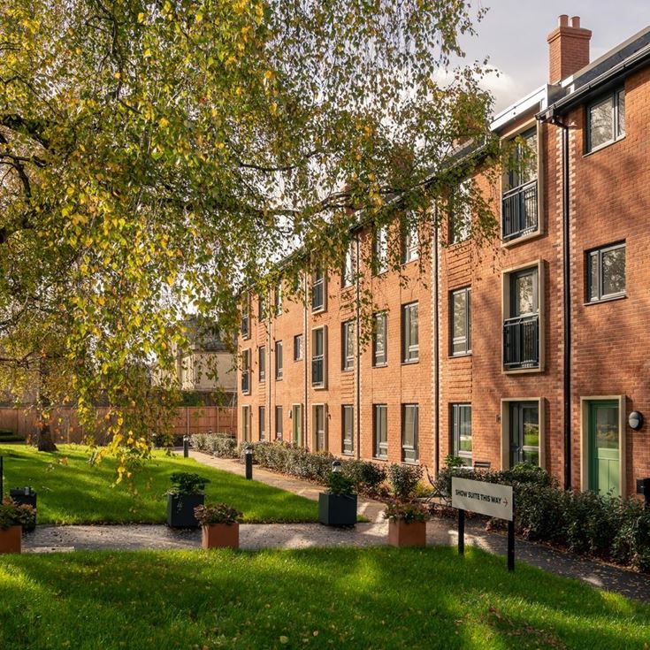 a brick building with trees in front