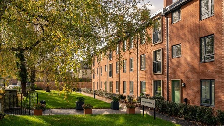 a brick building with trees in front