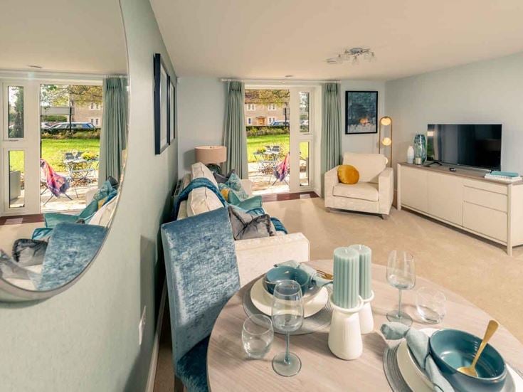 a living room with a table and chairs