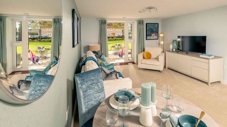 a living room with a table and chairs
