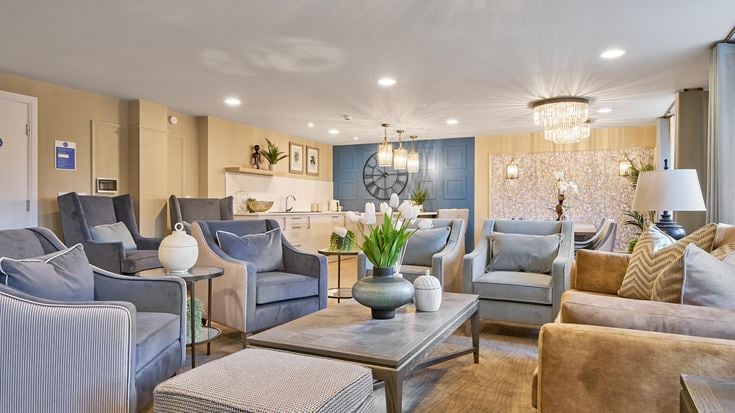 a living room with a large chandelier and a couch