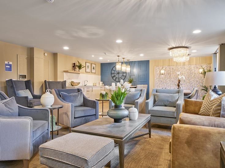 a living room with a large chandelier and a couch
