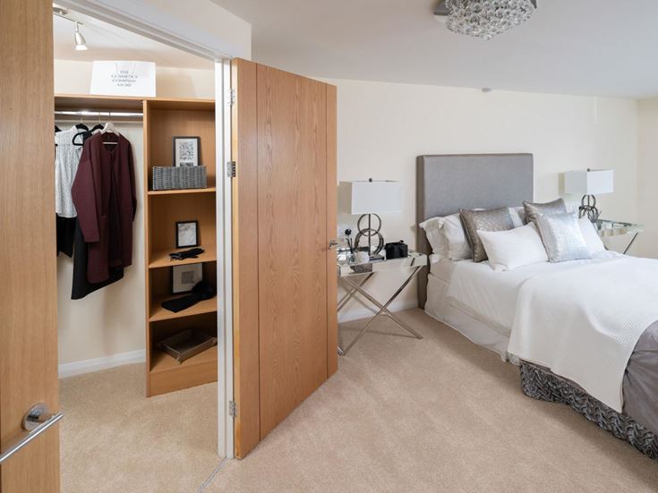 a bedroom with a closet and a bed