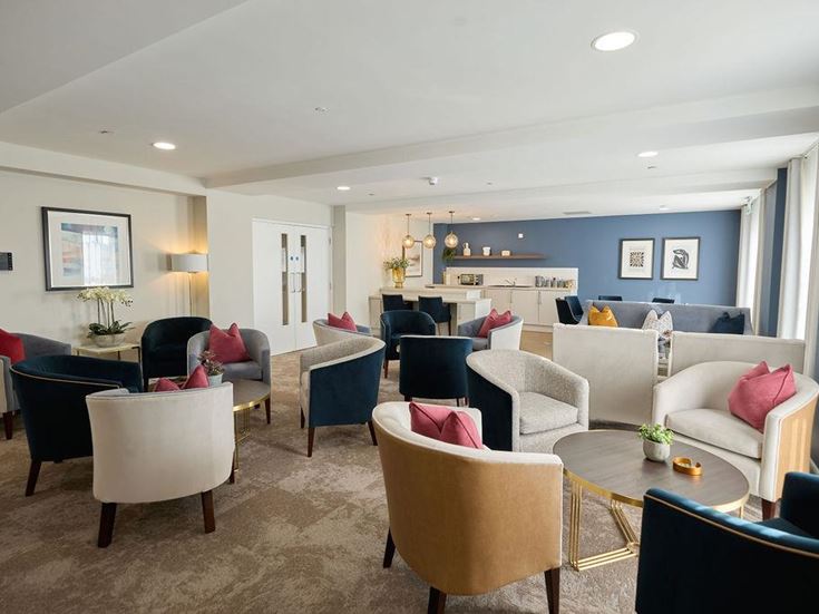 a living room with a couch and chairs