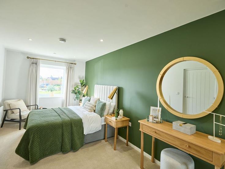 a bedroom with a mirror and a bed