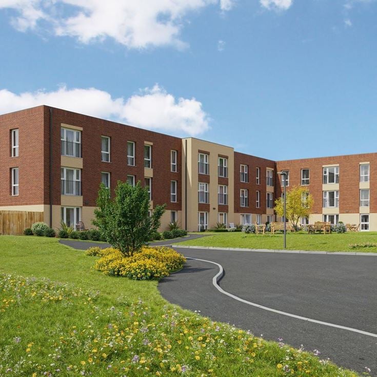 a large brick building with a parking lot in front of it
